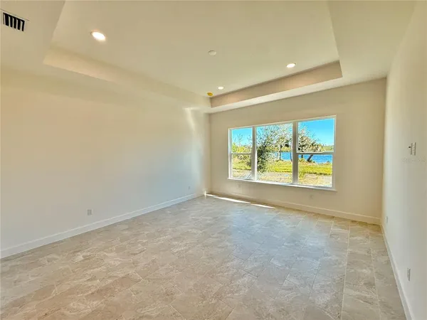 a bathroom with double vanity and a mirror