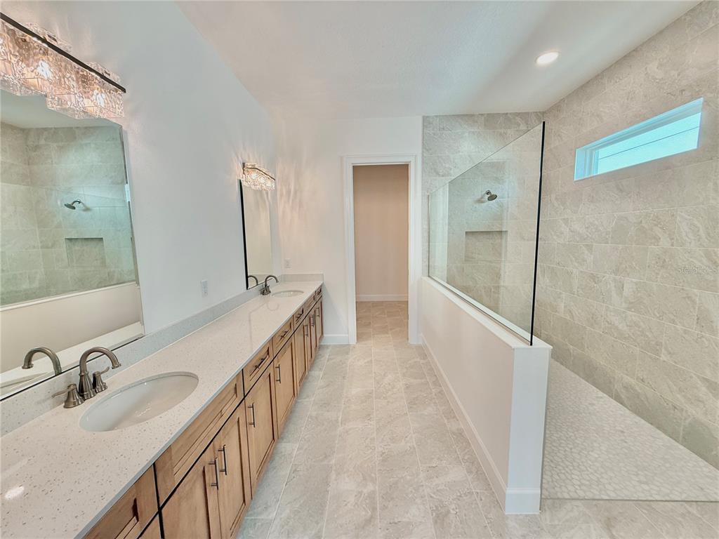 4 Coronado Road Flagler Beach, FL 32136 - Photo 43 of 63 a bathroom with double vanity and a bathtub