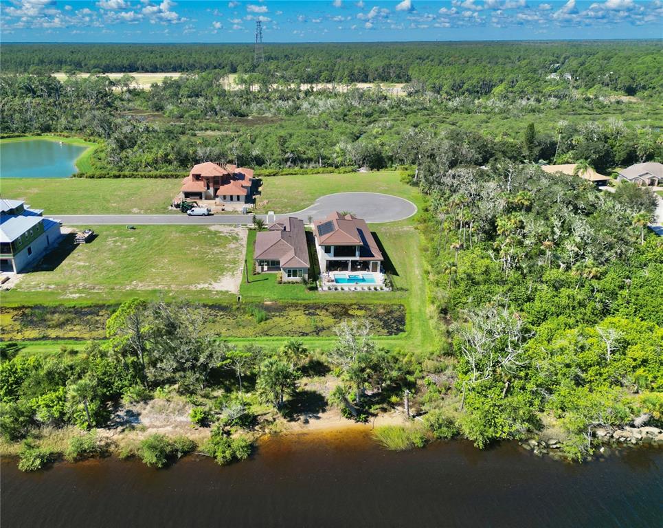 4 Coronado Road Flagler Beach, FL 32136 - Photo 60 of 63 a view of a garden with a lake