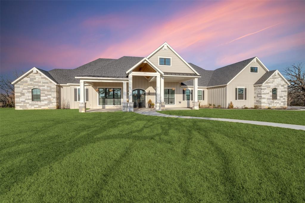 5165 Hartlee Field Road Denton, TX 76208 - Photo 30 of 39 a front view of a house with a garden and trees