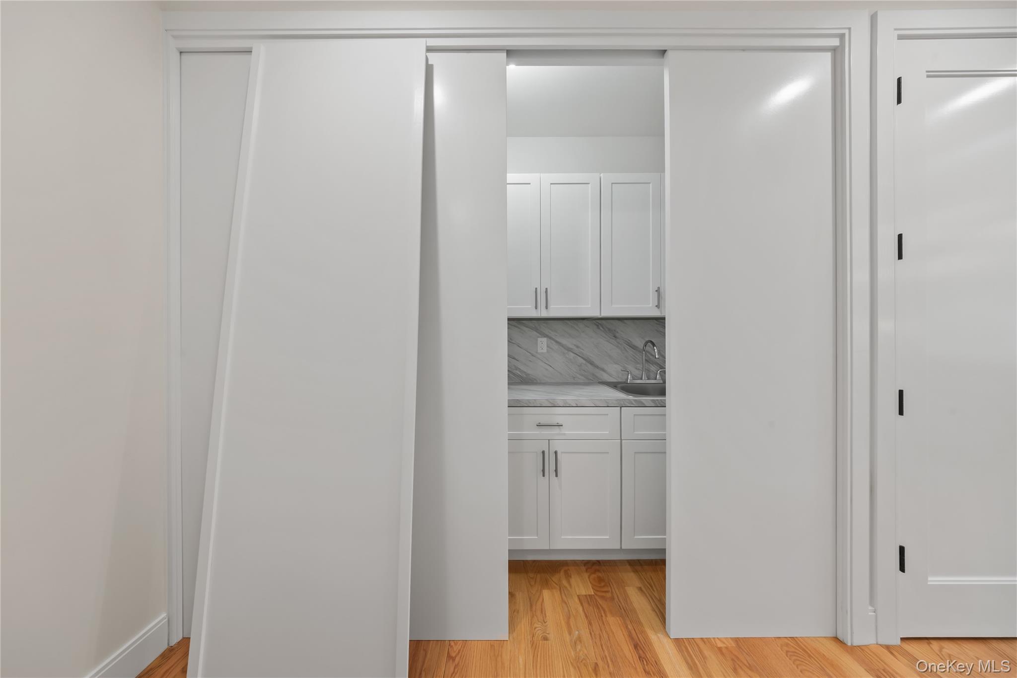 63 Dessau Circle, Unit 52 Spring Valley, NY 10977 - Photo 44 of 48 a room with a bench and wooden floor