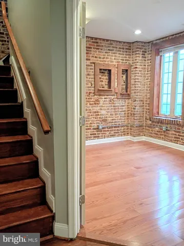 wooden floor in an empty room with stairs