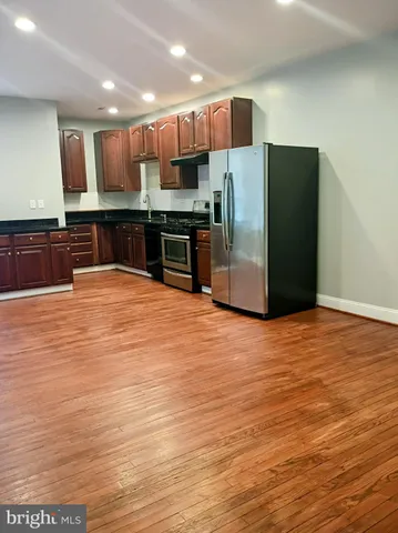 a kitchen with stainless steel appliances a refrigerator and a microwave