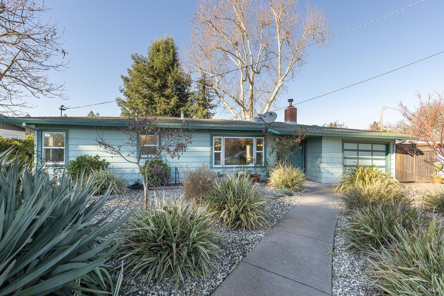 a front view of a house with yard and green space
