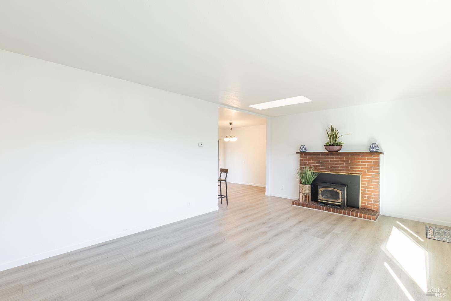 1225 Matanzas Way Santa Rosa, CA 95405 - Photo 11 of 44 a view of an empty room with wooden floor fireplace and a window
