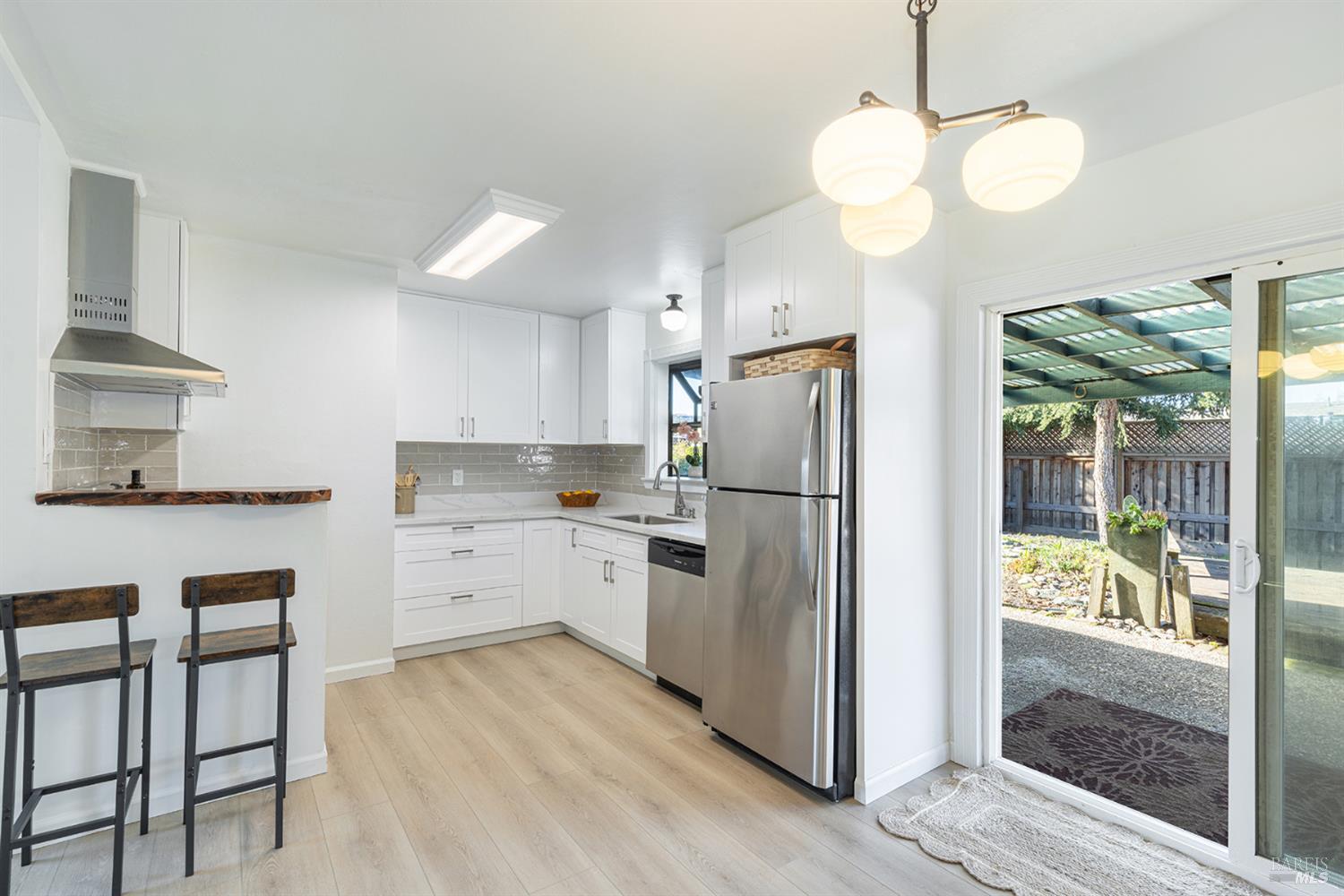 1225 Matanzas Way Santa Rosa, CA 95405 - Photo 13 of 44 a kitchen with white cabinets and stainless steel appliances