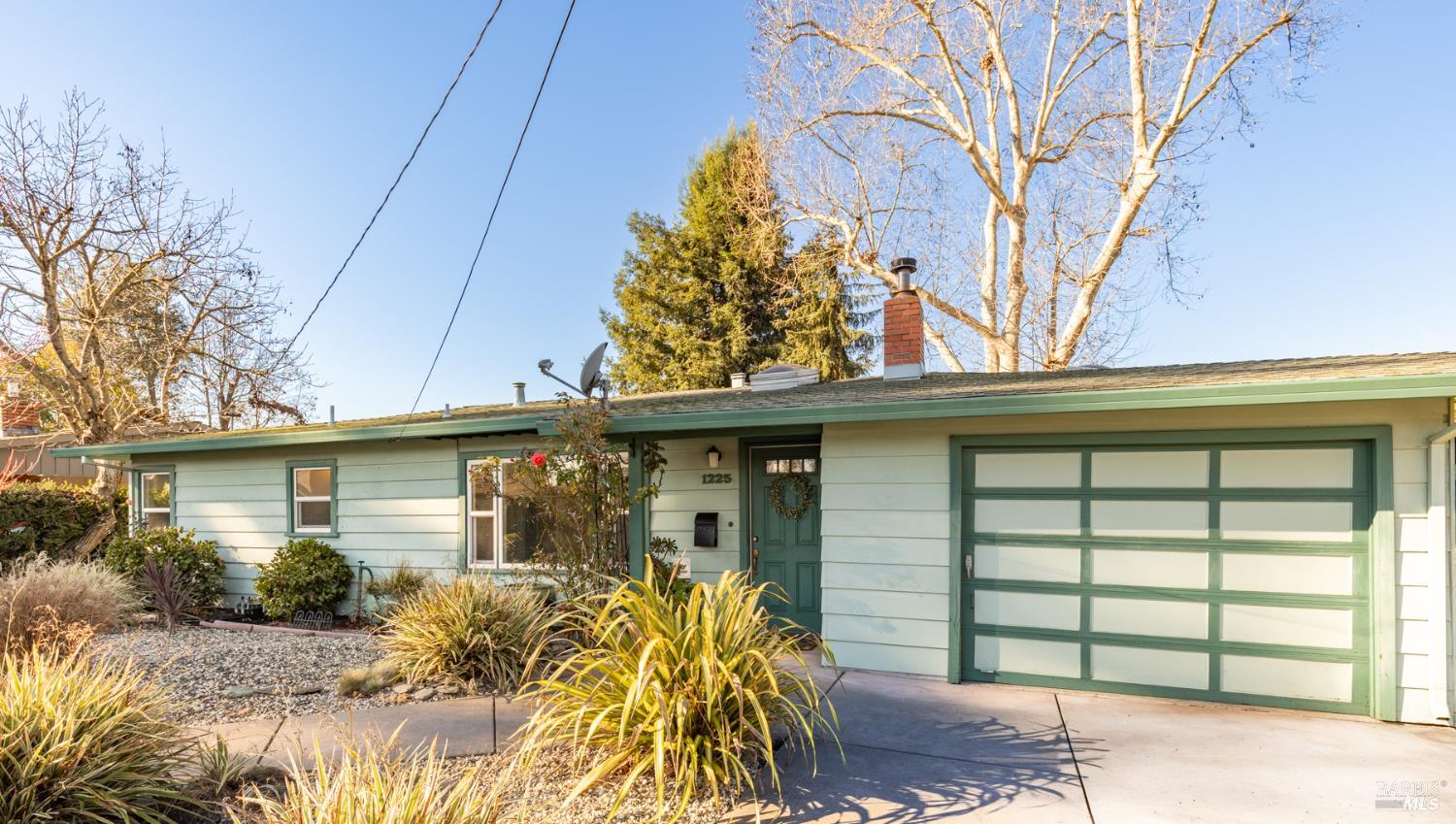 1225 Matanzas Way Santa Rosa, CA 95405 - Photo 2 of 44 a yellow house with trees in front of it