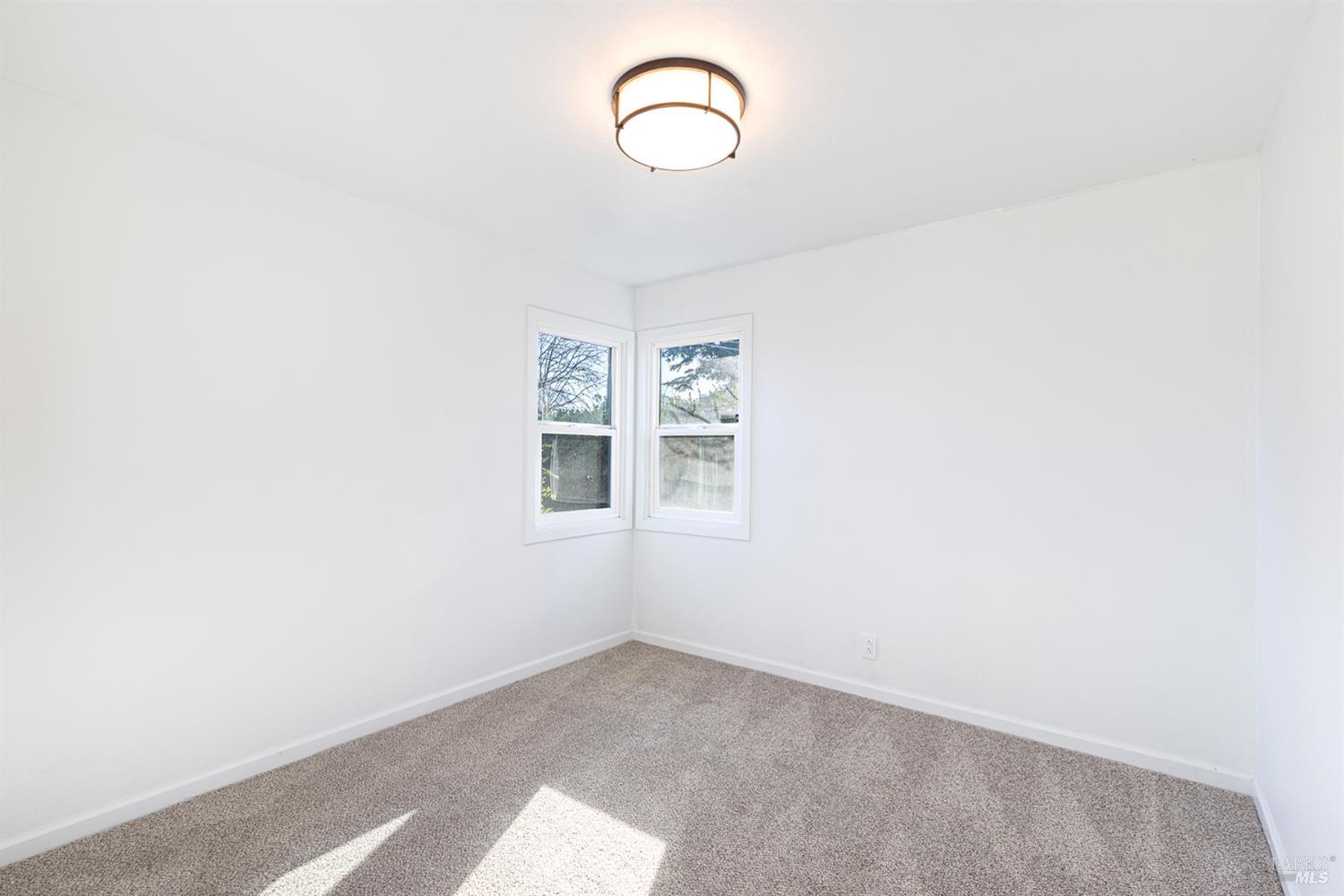 1225 Matanzas Way Santa Rosa, CA 95405 - Photo 22 of 44 a room with a white wall and a window