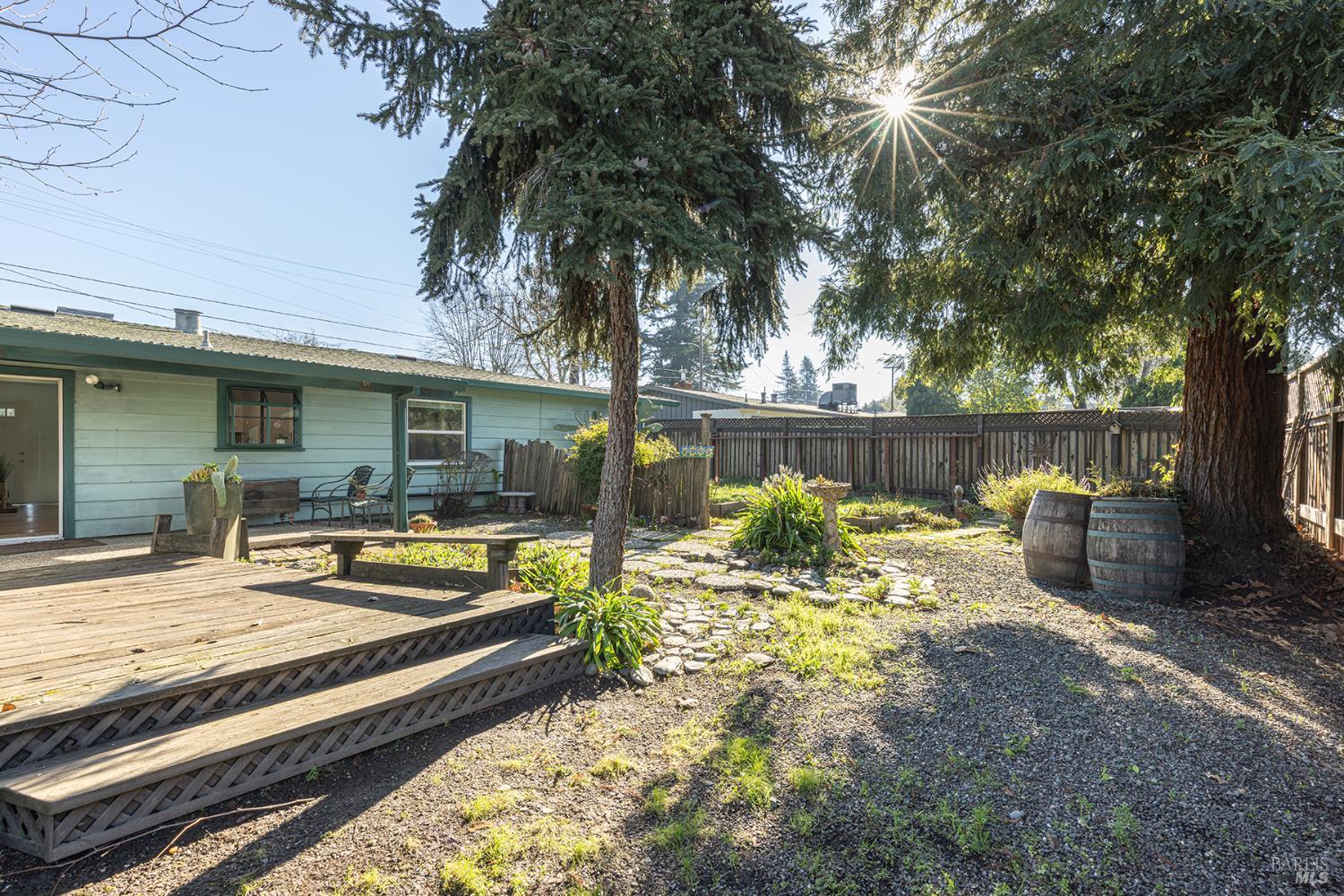 1225 Matanzas Way Santa Rosa, CA 95405 - Photo 41 of 44 a view of a patio with table and chairs and wooden fence