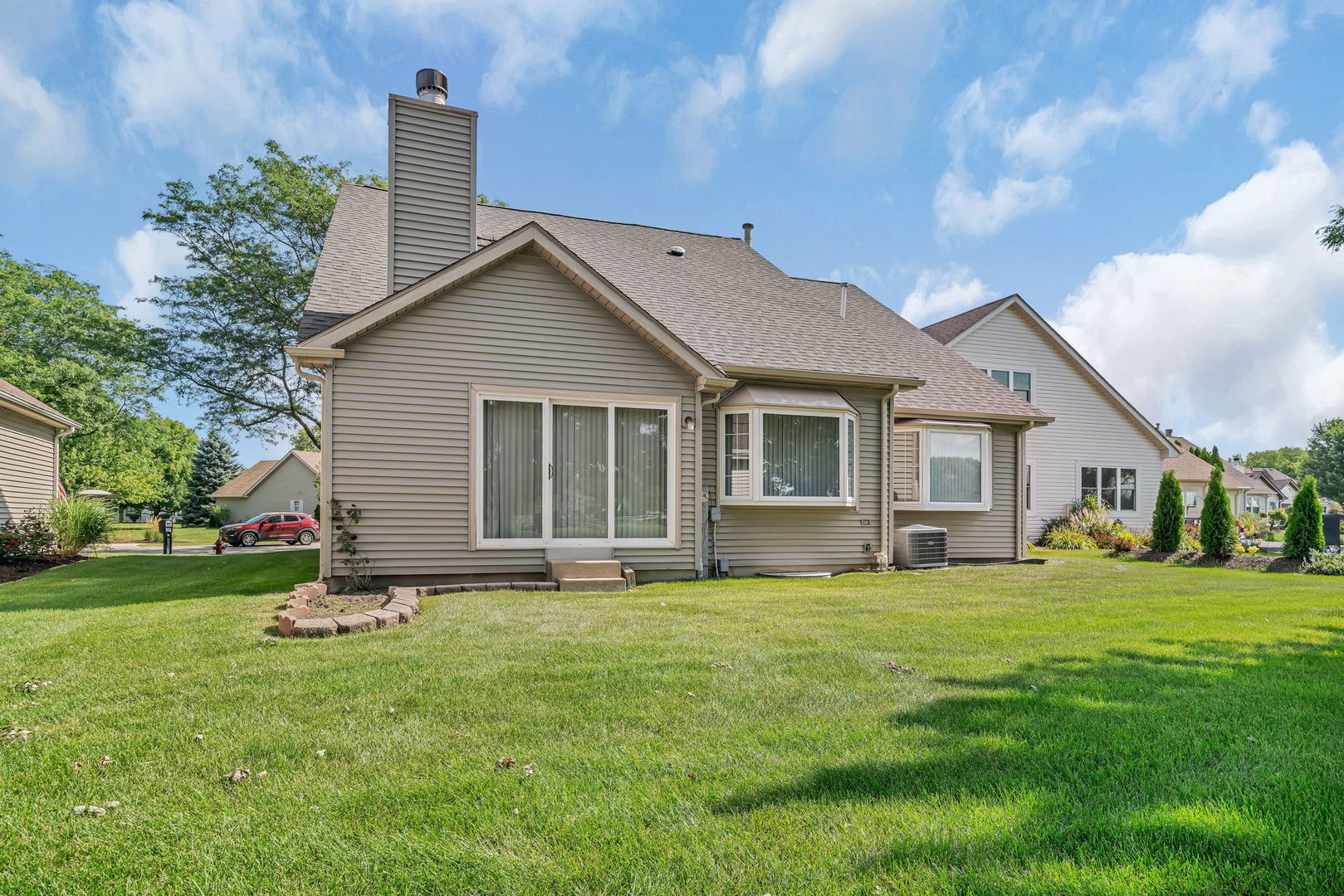 13472 Redberry Circle Plainfield, IL 60544 - Photo 27 of 30 a house that is sitting in the grass with large trees and plants