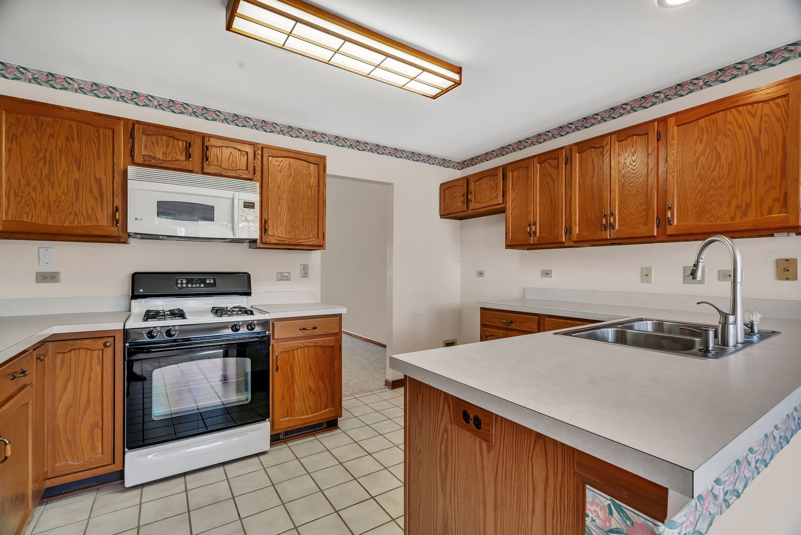 13472 Redberry Circle Plainfield, IL 60544 - Photo 7 of 30 a kitchen with stainless steel appliances granite countertop a stove a sink and a microwave
