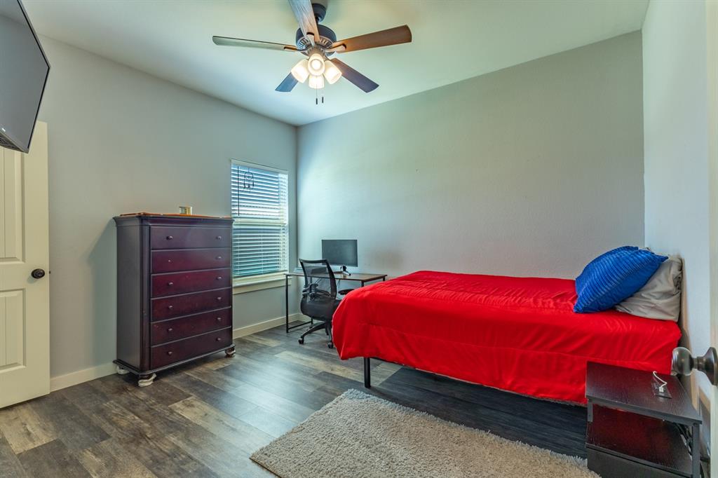 14910 Old Stoney Road Ponder, TX 76259 - Photo 24 of 36 a bedroom with a bed and a chandelier