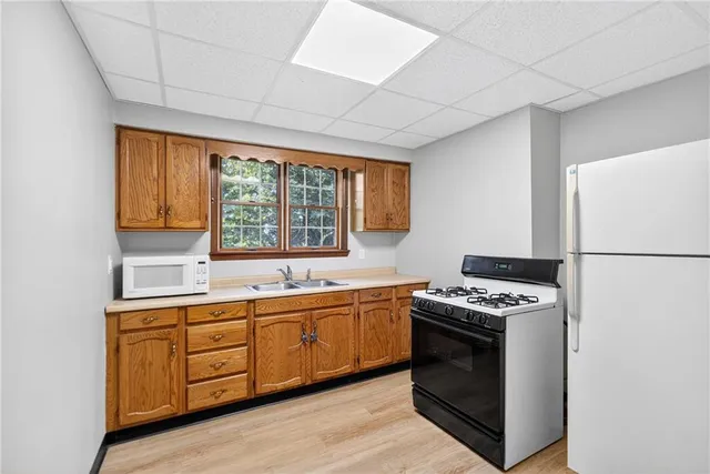 a kitchen with stainless steel appliances a stove a sink and a refrigerator