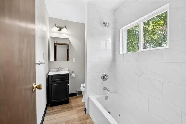 a bathroom with a bathtub and a sink