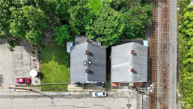 an aerial view of a house with a yard and garden