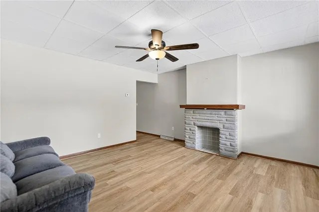 an empty room with furniture and a fireplace