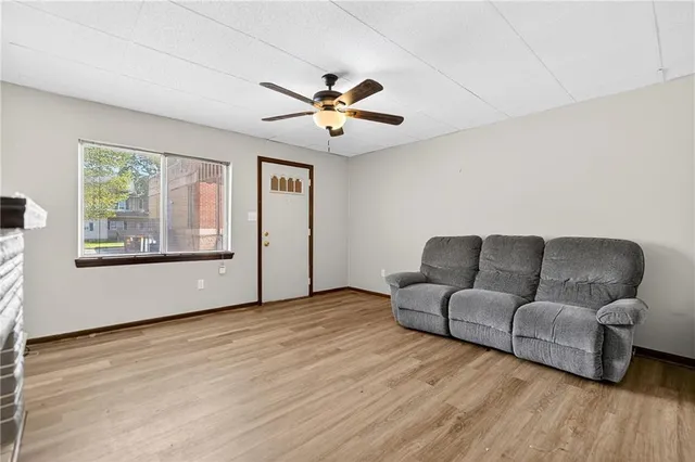 a living room with furniture and a ceiling fan