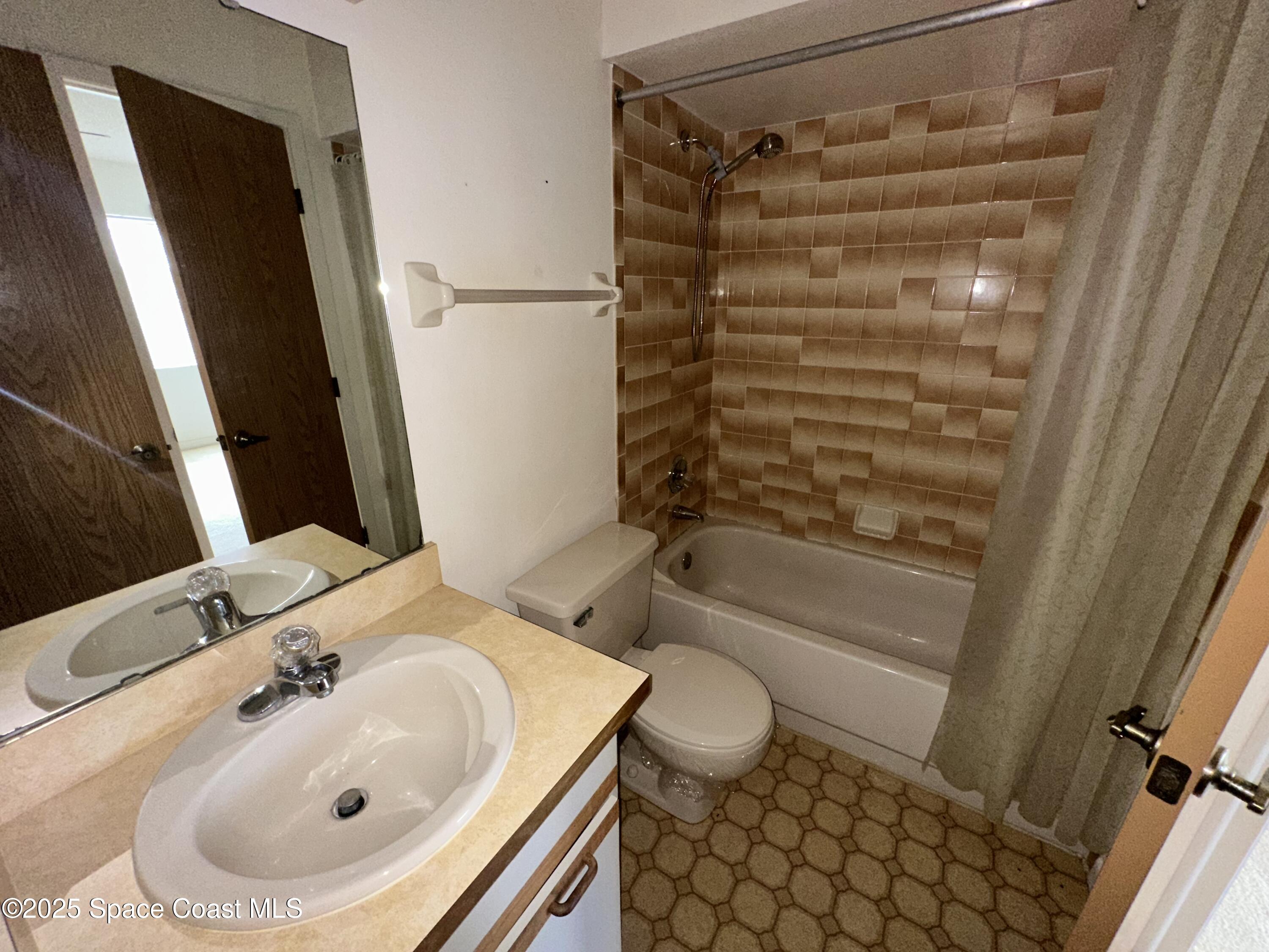 1882 Murrell Road, Unit J36 Rockledge, FL 32955 - Photo 11 of 12 a bathroom with a sink toilet and shower