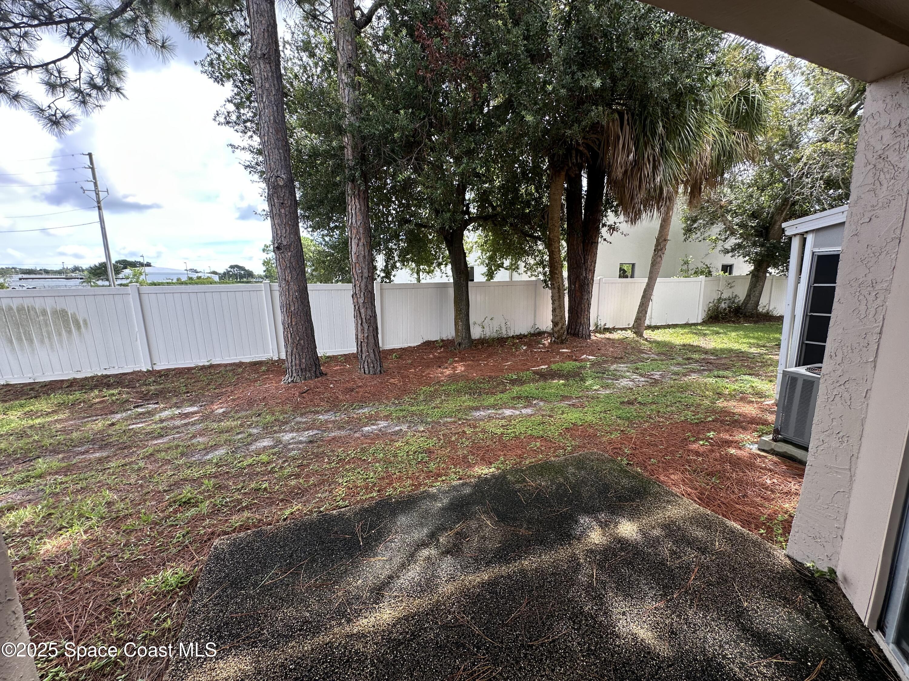 1882 Murrell Road, Unit J36 Rockledge, FL 32955 - Photo 3 of 12 a view of a yard with a tree