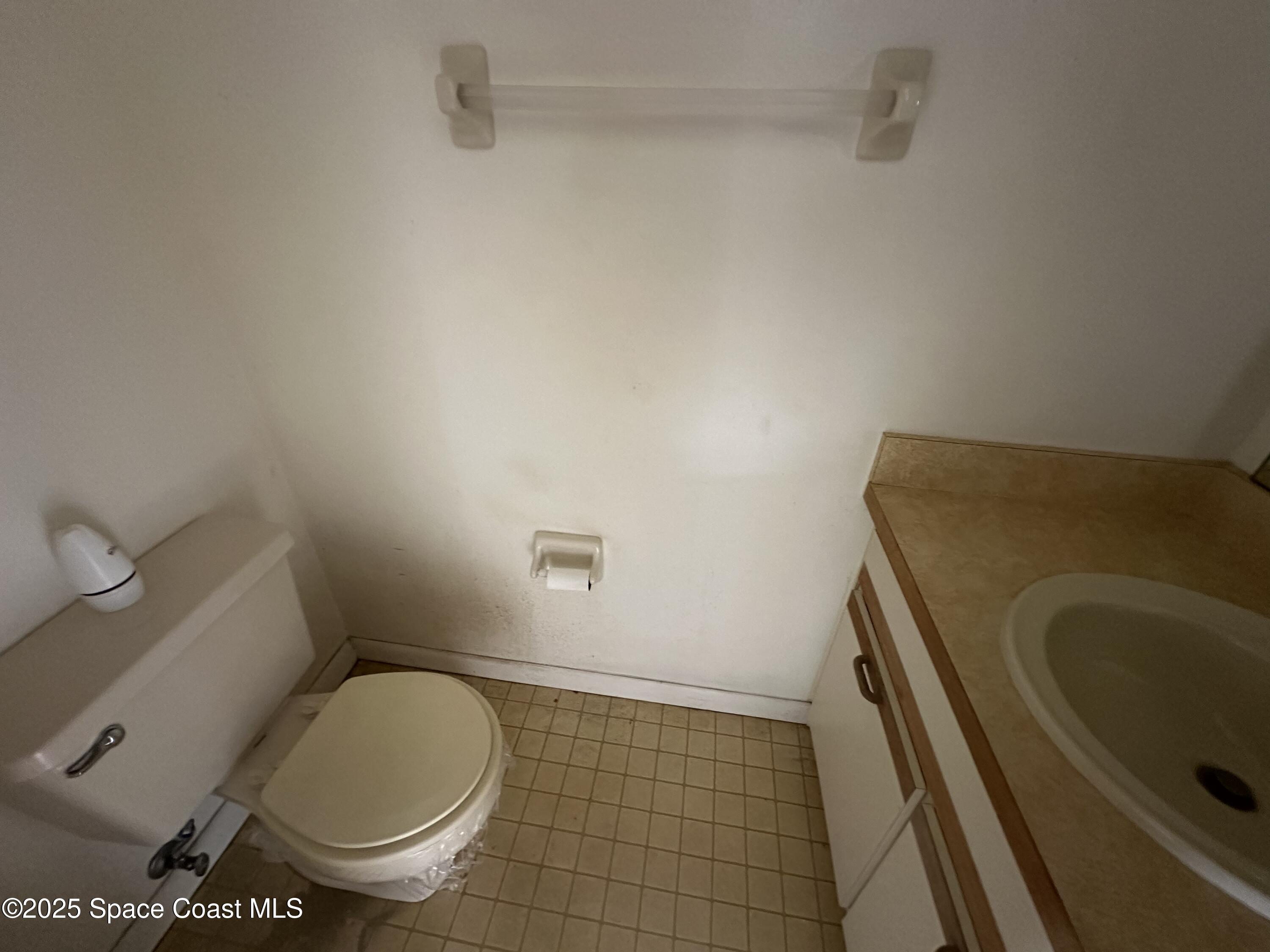 1882 Murrell Road, Unit J36 Rockledge, FL 32955 - Photo 7 of 12 a bathroom with a sink and toilet