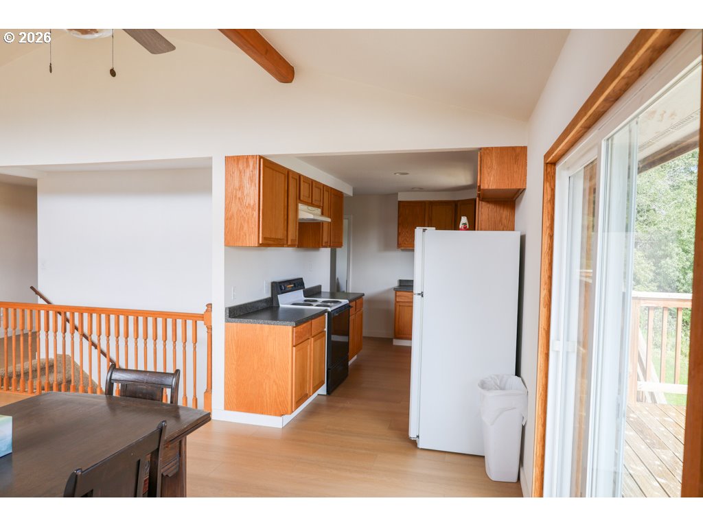 610 Tiara Street Lakeside, OR 97449 - Photo 11 of 28 a kitchen with a refrigerator and a sink