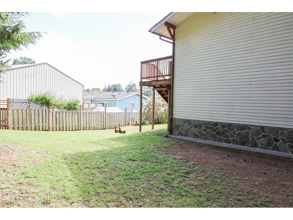 610 Tiara Street Lakeside, OR 97449 - Photo 24 of 28 a view of a backyard with a garden