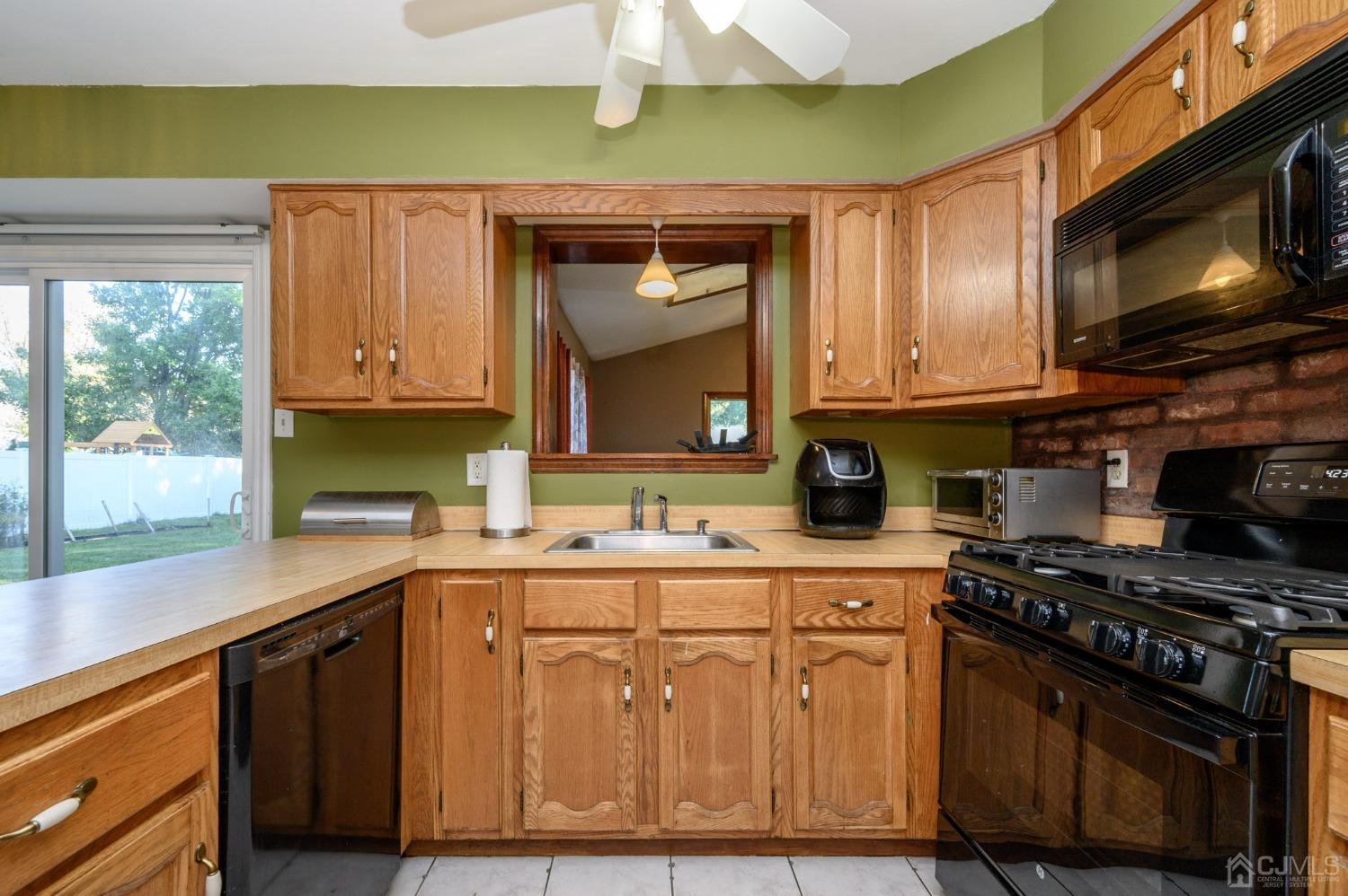 7 Blueberry Path Howell, NJ 07731 - Photo 15 of 39 a kitchen with stainless steel appliances granite countertop a stove a sink and a microwave