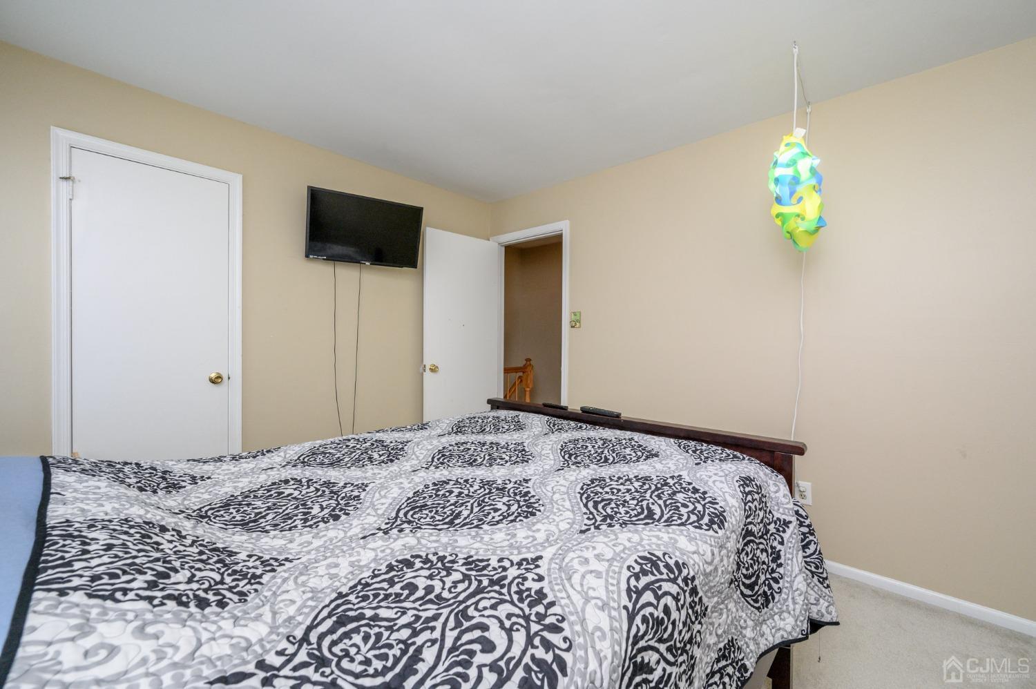 7 Blueberry Path Howell, NJ 07731 - Photo 26 of 39 a bedroom with a bed and a chandelier
