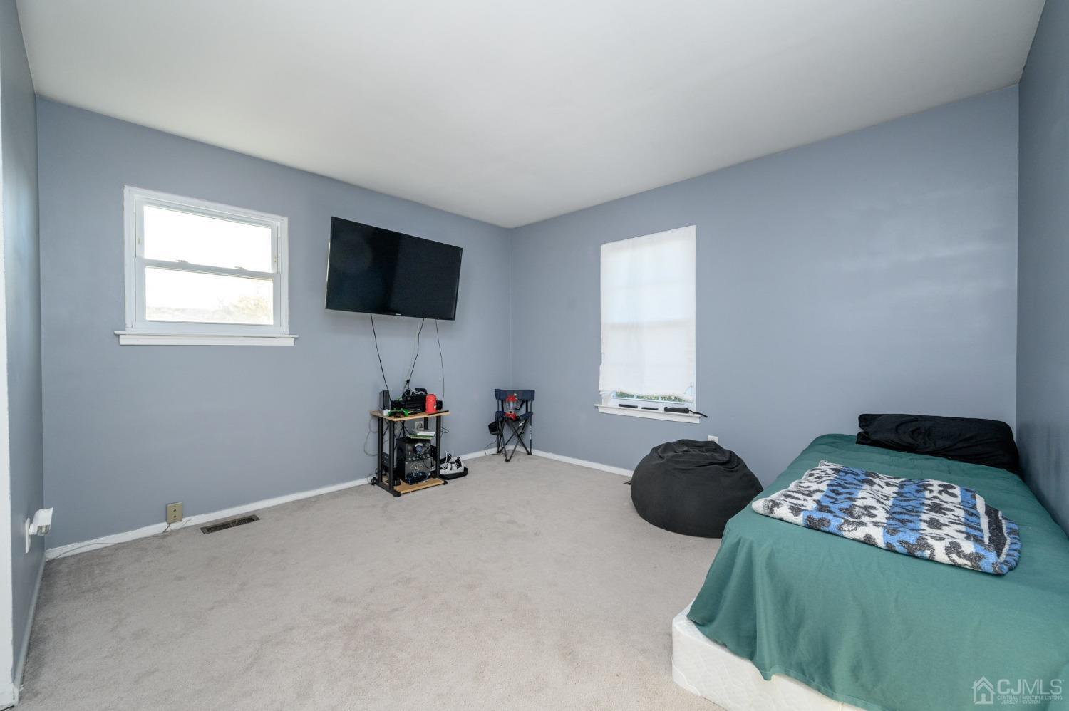 7 Blueberry Path Howell, NJ 07731 - Photo 27 of 39 a bedroom with two beds and a flat screen tv