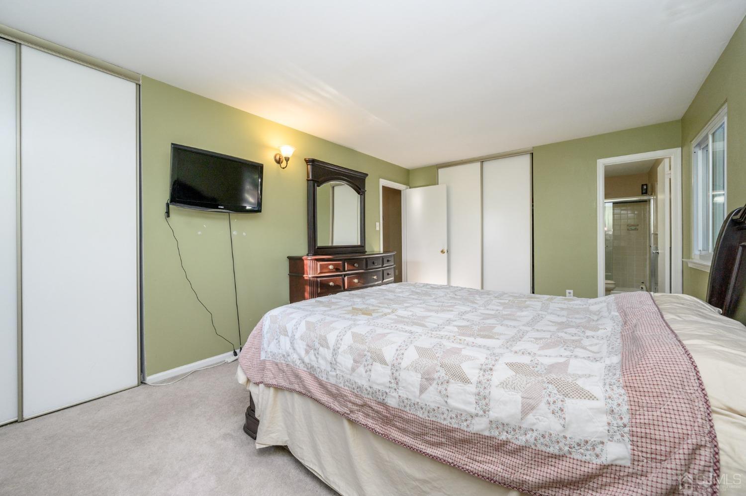 7 Blueberry Path Howell, NJ 07731 - Photo 32 of 39 a bedroom with a bed and a flat screen tv