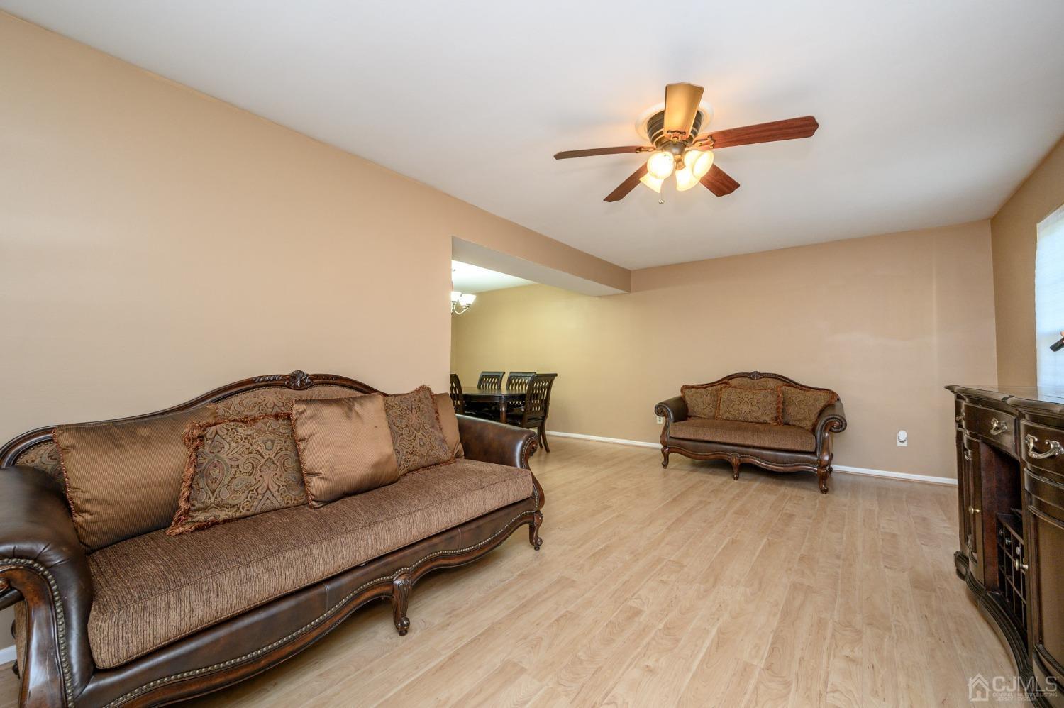 7 Blueberry Path Howell, NJ 07731 - Photo 5 of 39 a living room with furniture and a wooden floor