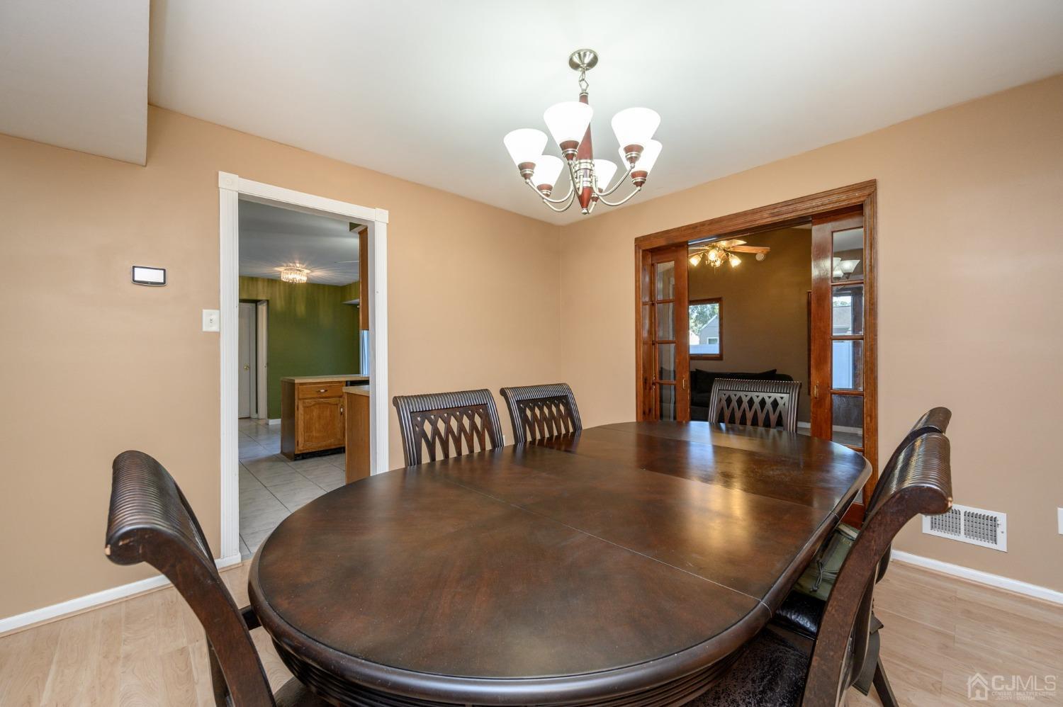 7 Blueberry Path Howell, NJ 07731 - Photo 9 of 39 a dining room with furniture a chandelier and wooden floor