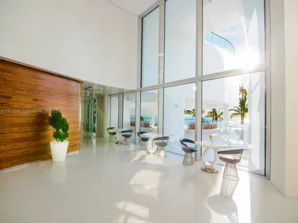 a living room with fireplace furniture and a large window