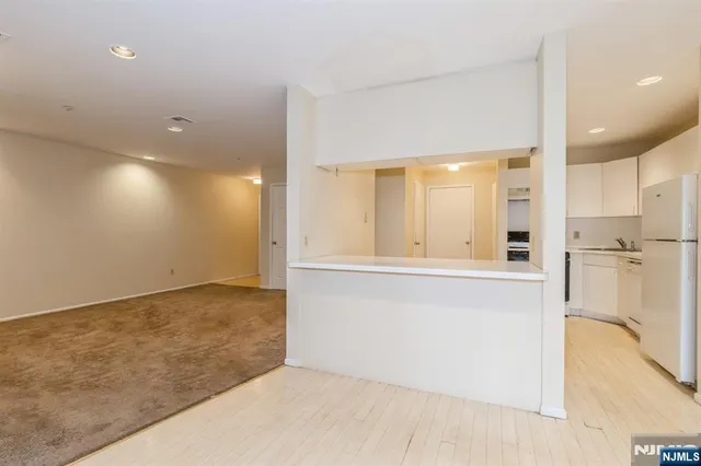 a kitchen with granite countertop cabinets stainless steel appliances and a sink