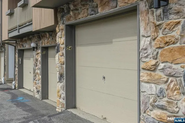a view of a door and brick wall
