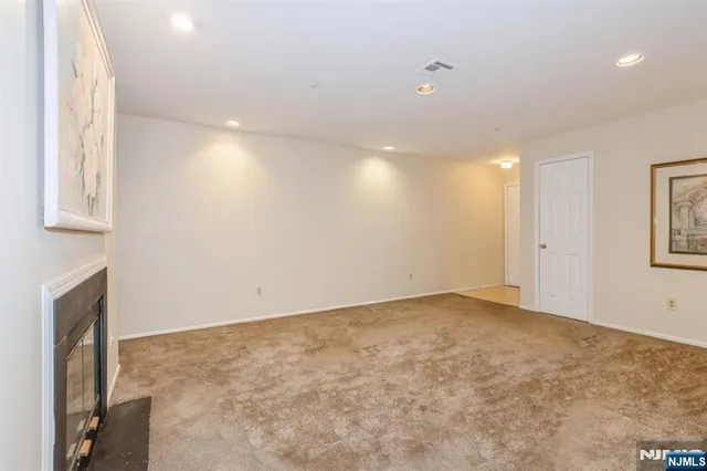 a view of an empty room with a fireplace