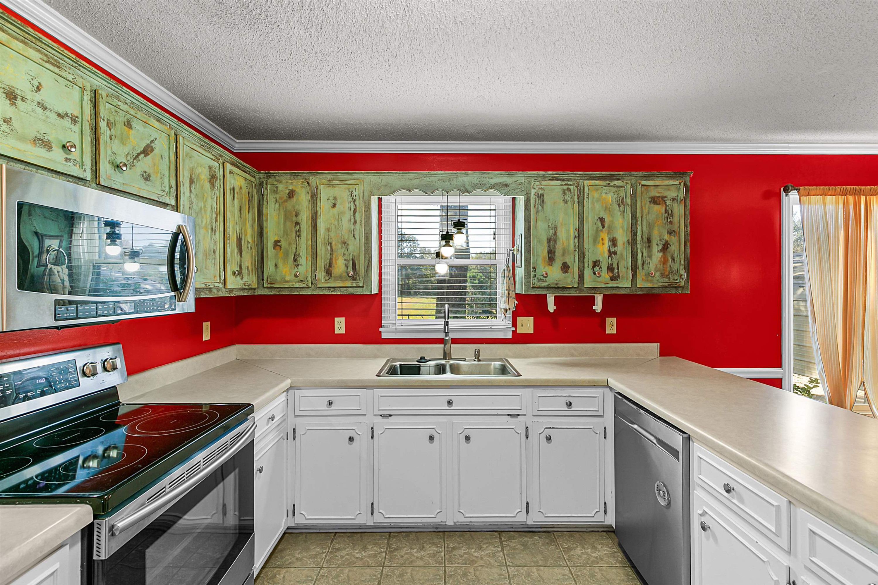 30 Hopewell Church Road Lavinia, TN 38348 - Photo 10 of 31 a kitchen with a stove a sink and a microwave