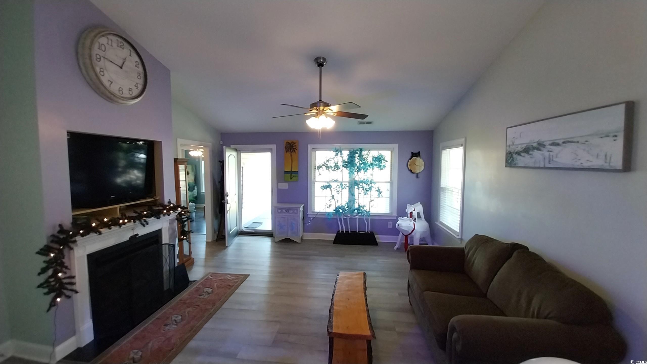 1210 Horry Road Aynor, SC 29511 - Photo 4 of 34 Living area featuring wood finished floors, a fire