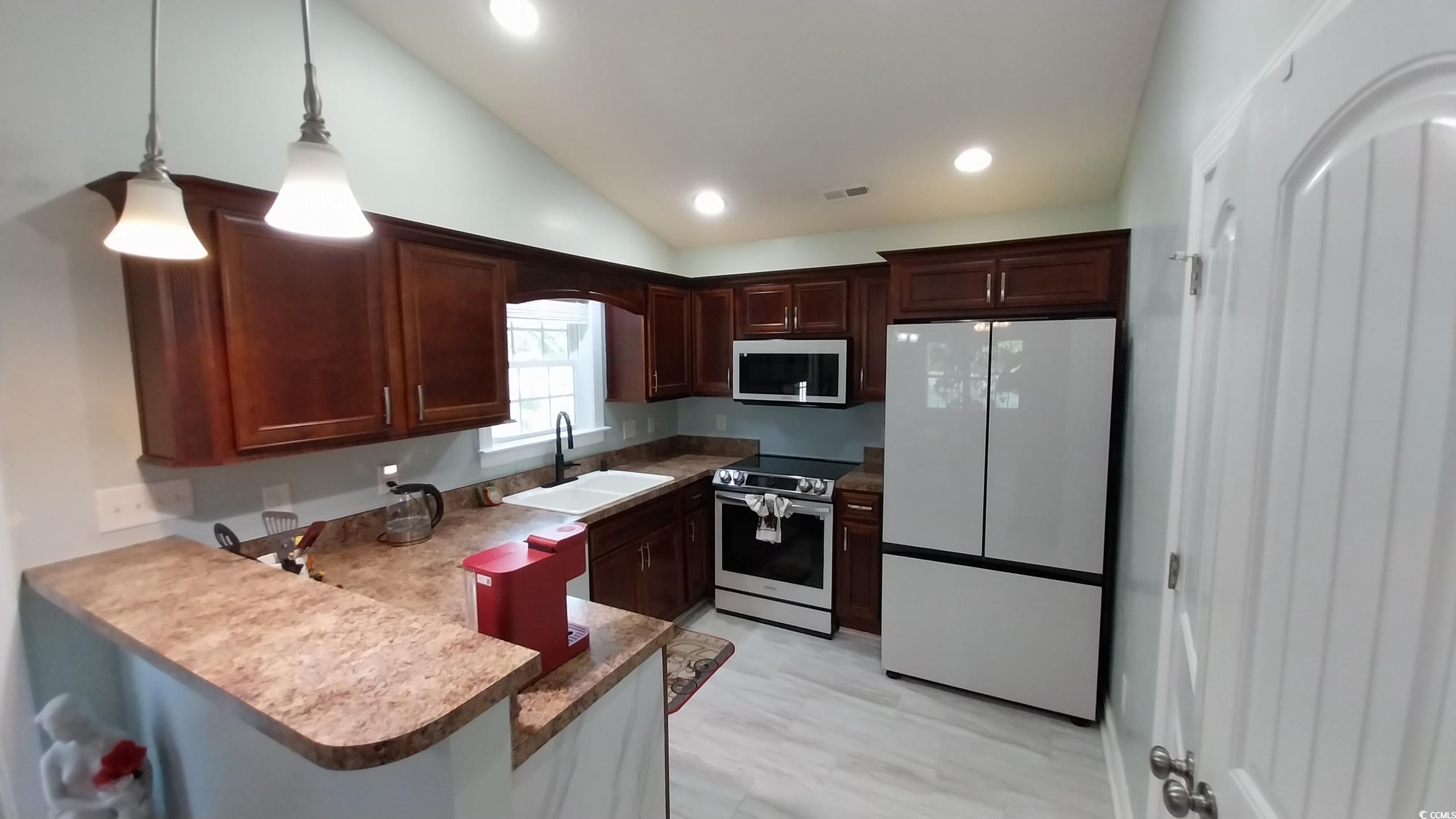 1210 Horry Road Aynor, SC 29511 - Photo 5 of 34 Kitchen with vaulted ceiling, a peninsula, decorat