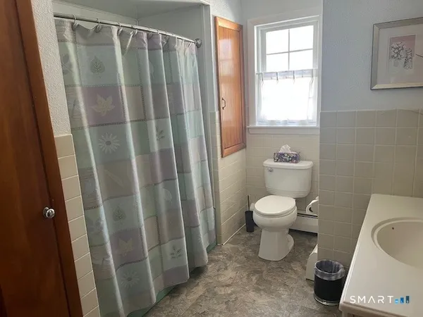 a bathroom with a toilet and a shower