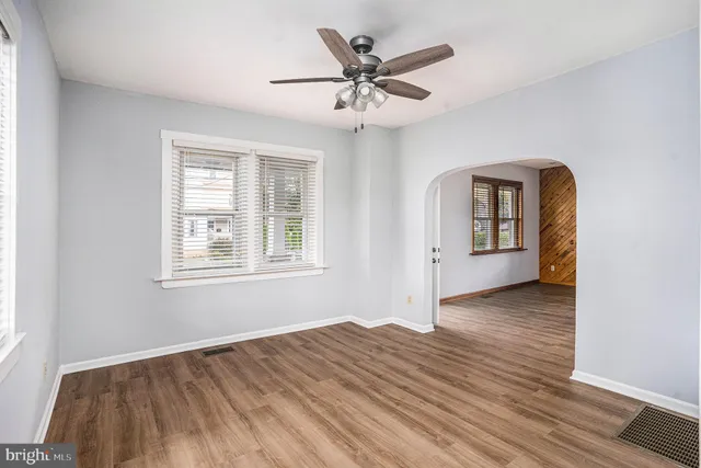 wooden floor in an empty room with a window