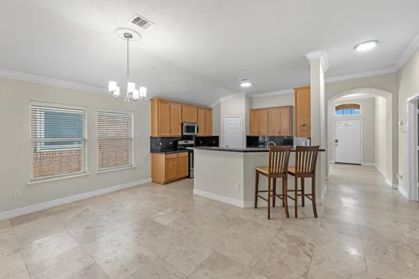 a view of kitchen with refrigerator and window