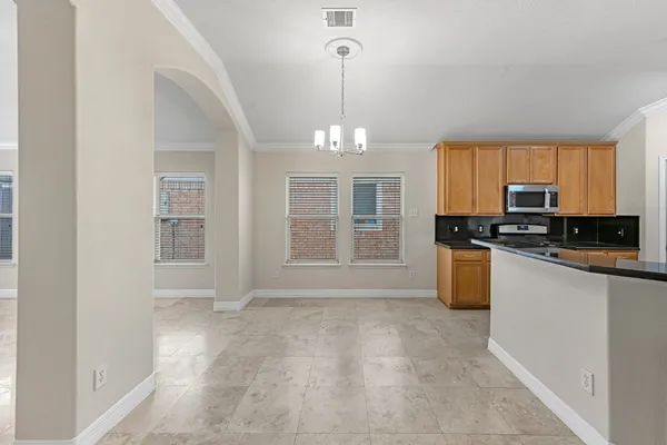 a view of a kitchen with granite countertop cabinets