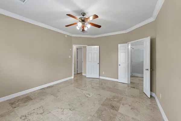 an empty room with chandelier fan
