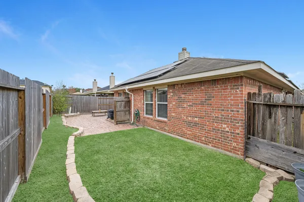 a view of a house with a yard and deck