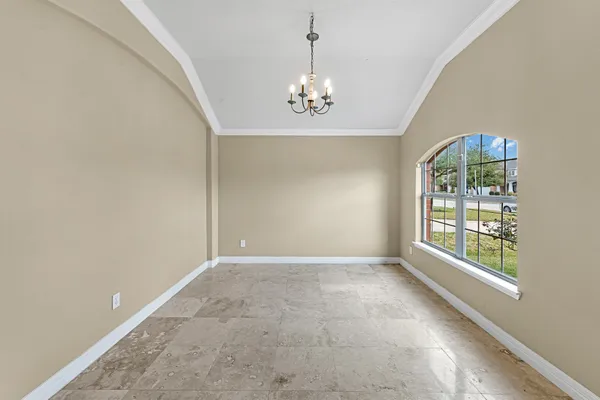 an empty room with windows and entrance