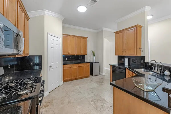 a kitchen with stainless steel appliances granite countertop a sink stove and refrigerator