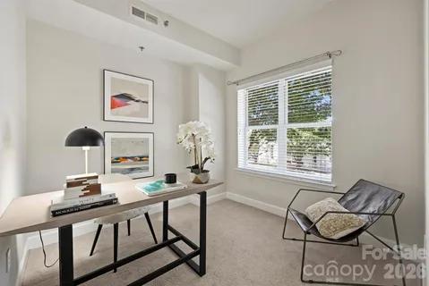 a bedroom with a bed and large window