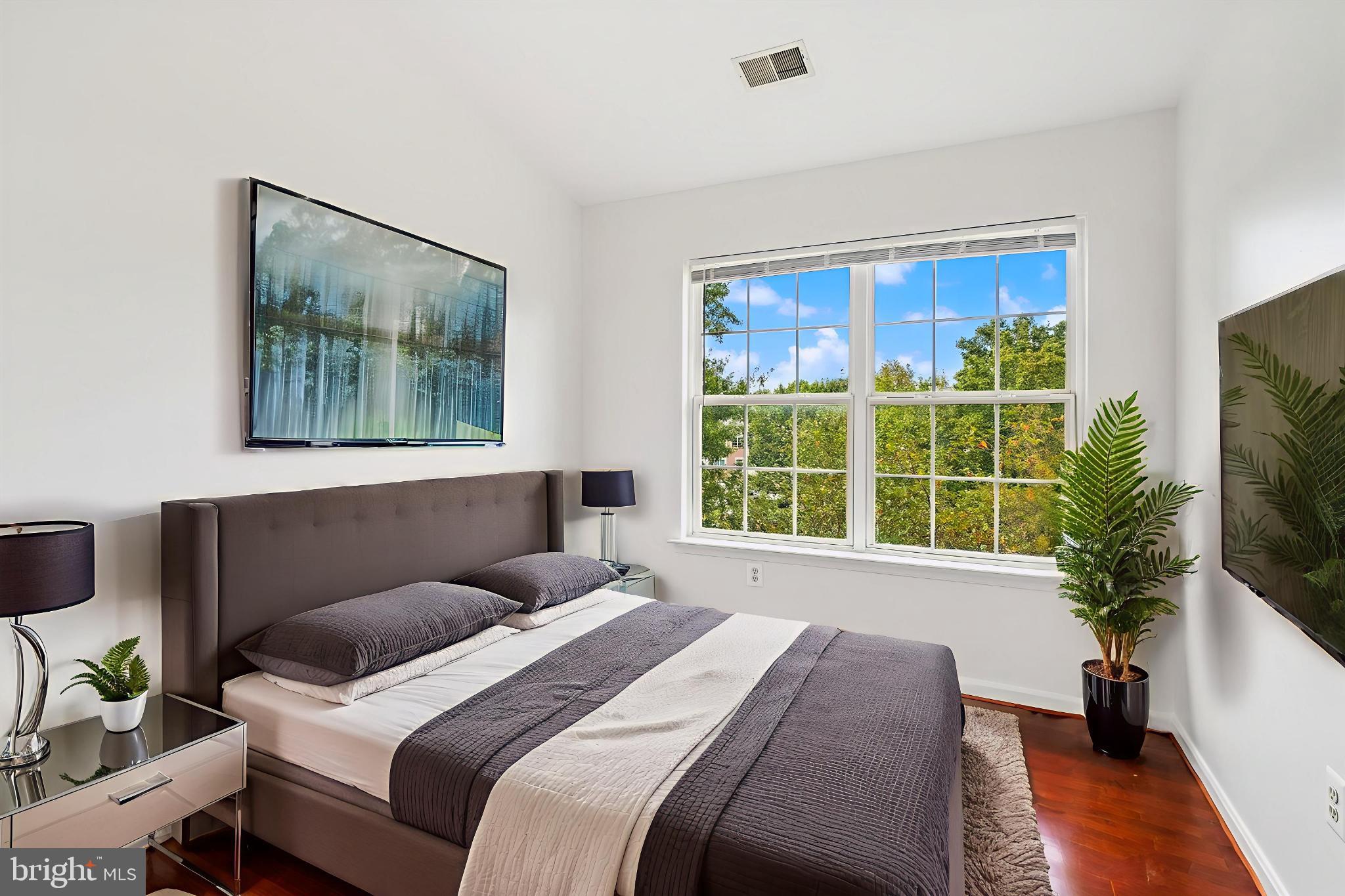 3281 Gina Place Woodbridge, VA 22193 - Photo 13 of 27 a bedroom with a large bed and a flat screen tv