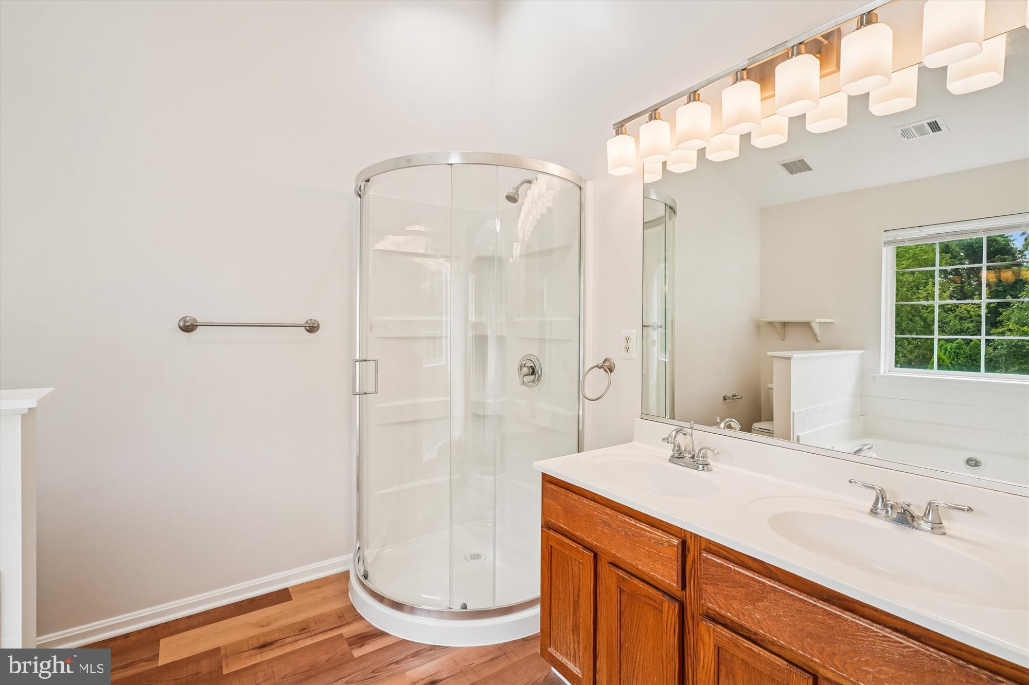 3281 Gina Place Woodbridge, VA 22193 - Photo 9 of 27 a bathroom with a shower sink and mirror